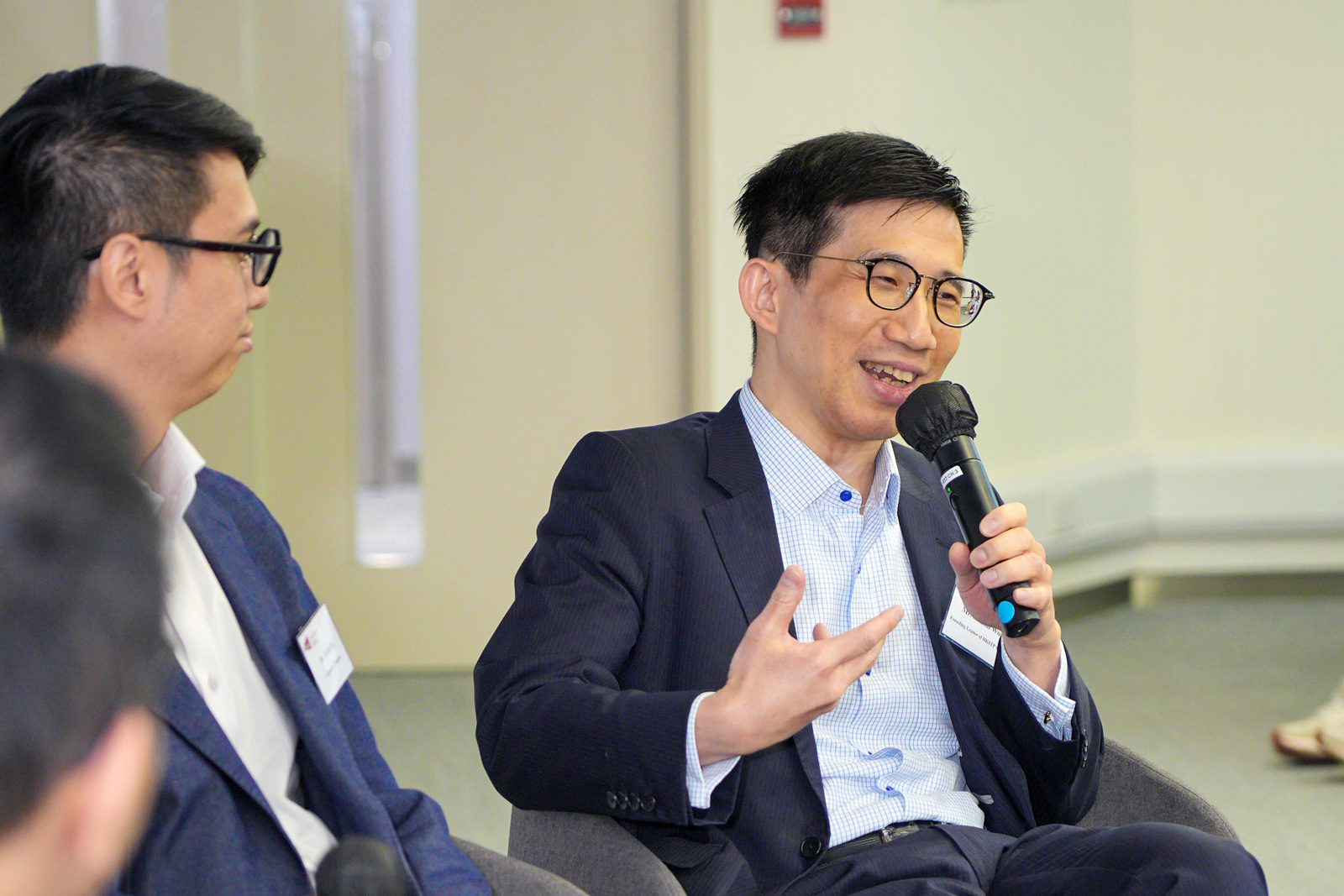 Mr Sammi Wong exchanges his ideas with other panellists during the panel discussion