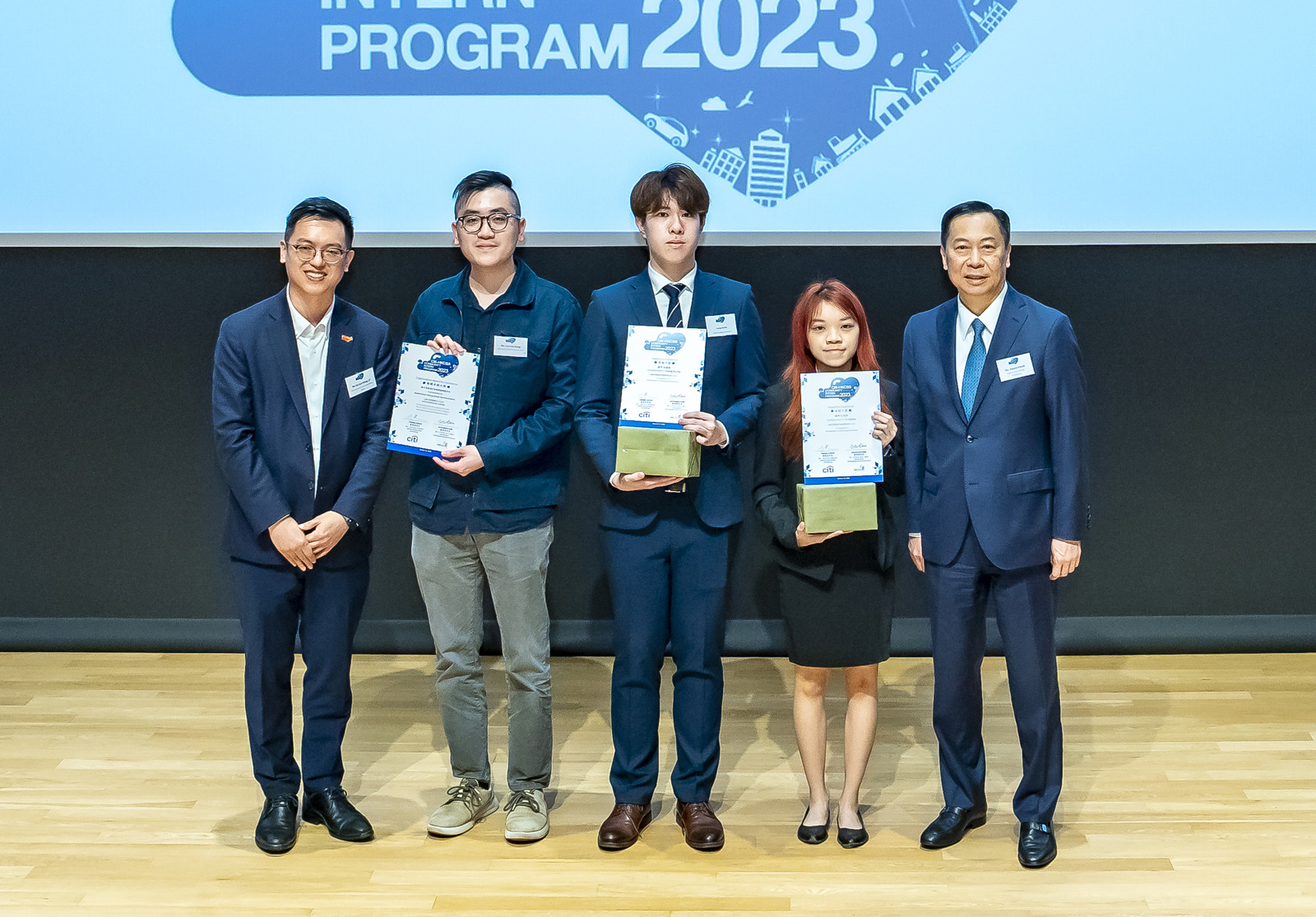 (Second from the right) Karen To receives the award certificate