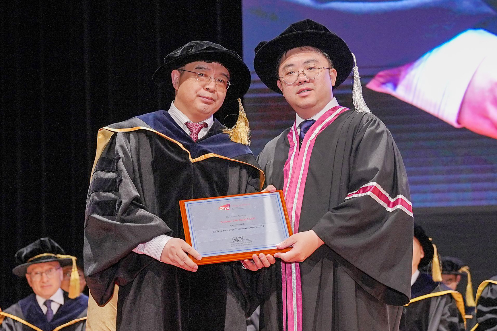 Prof. Junbo Wang (Head of Department of Economics and Finance) receives the College Research Excellence Award on behalf of Prof. David Yang Yilin (Department of Economics and Finance).