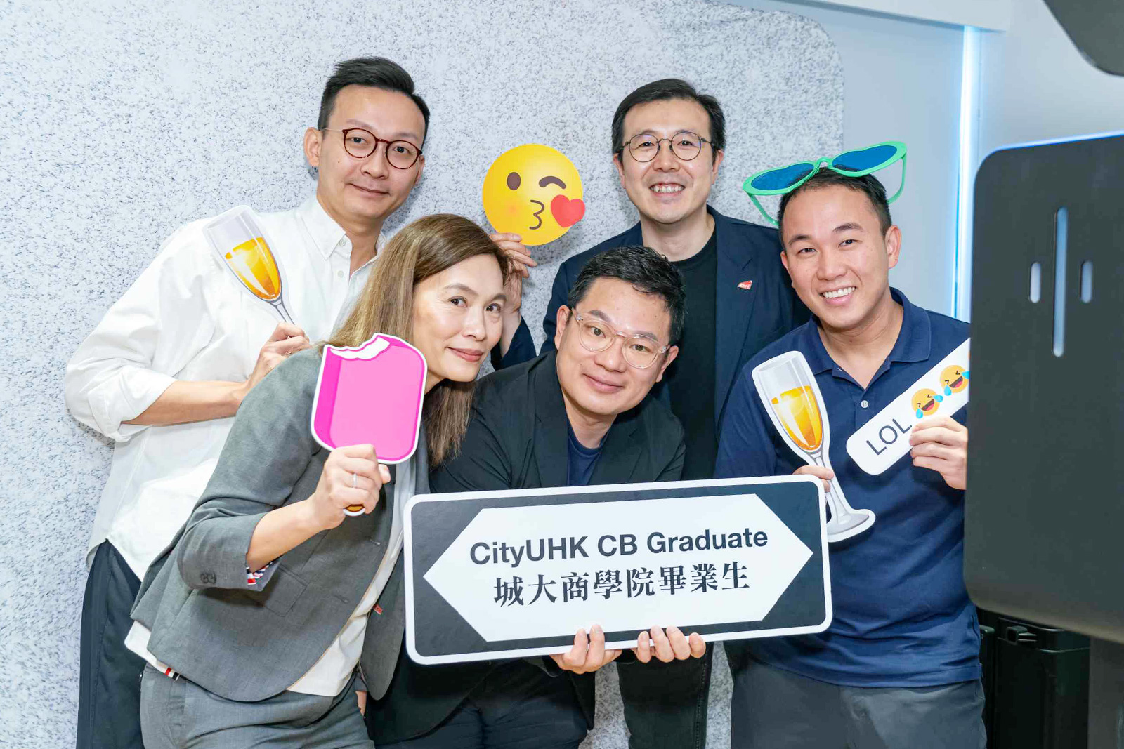 Alumni capture the special moment in the photo corner with Professor Raymond Wong, Associate Dean of Undergraduate Programmes (second from right).