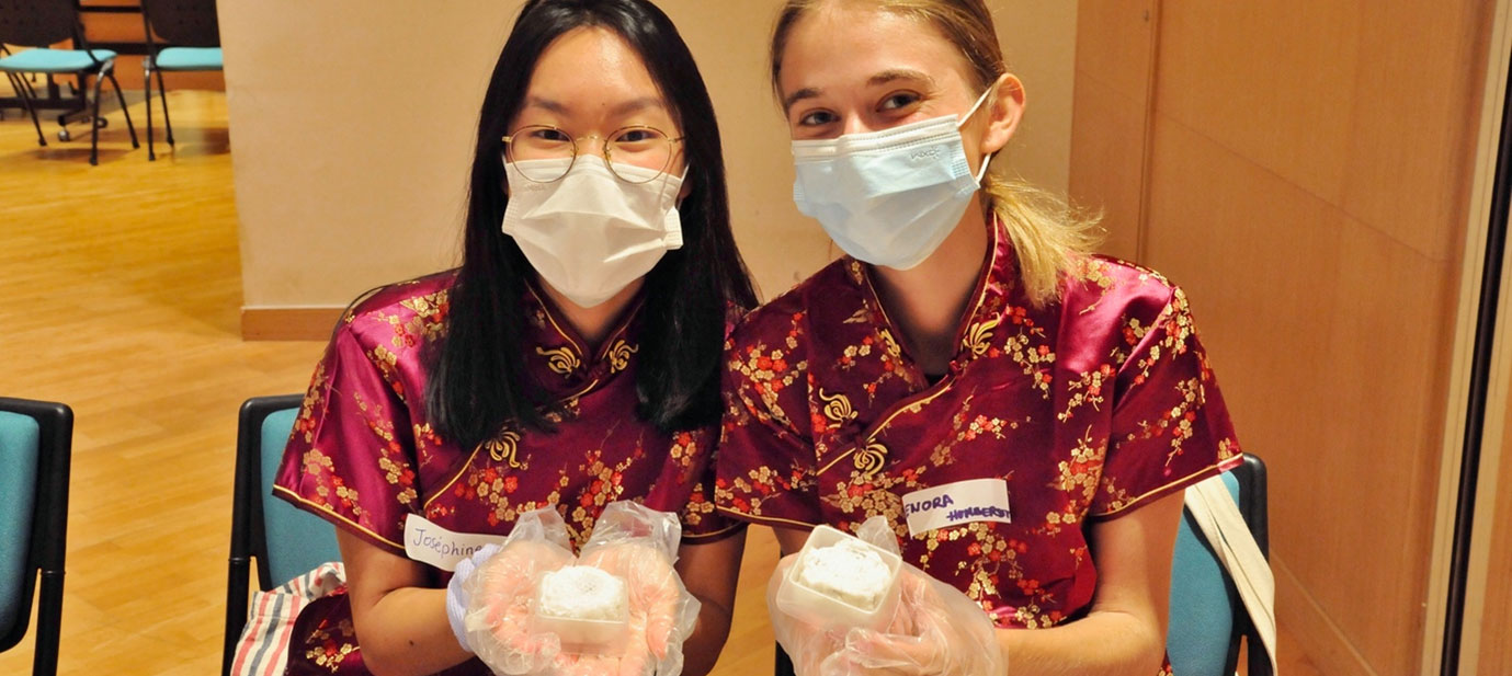 Local student shared the final moon-cake product with inbound student - Josephine Yong (Left) and Enora Humbersot from EDHEC, France (Right). 