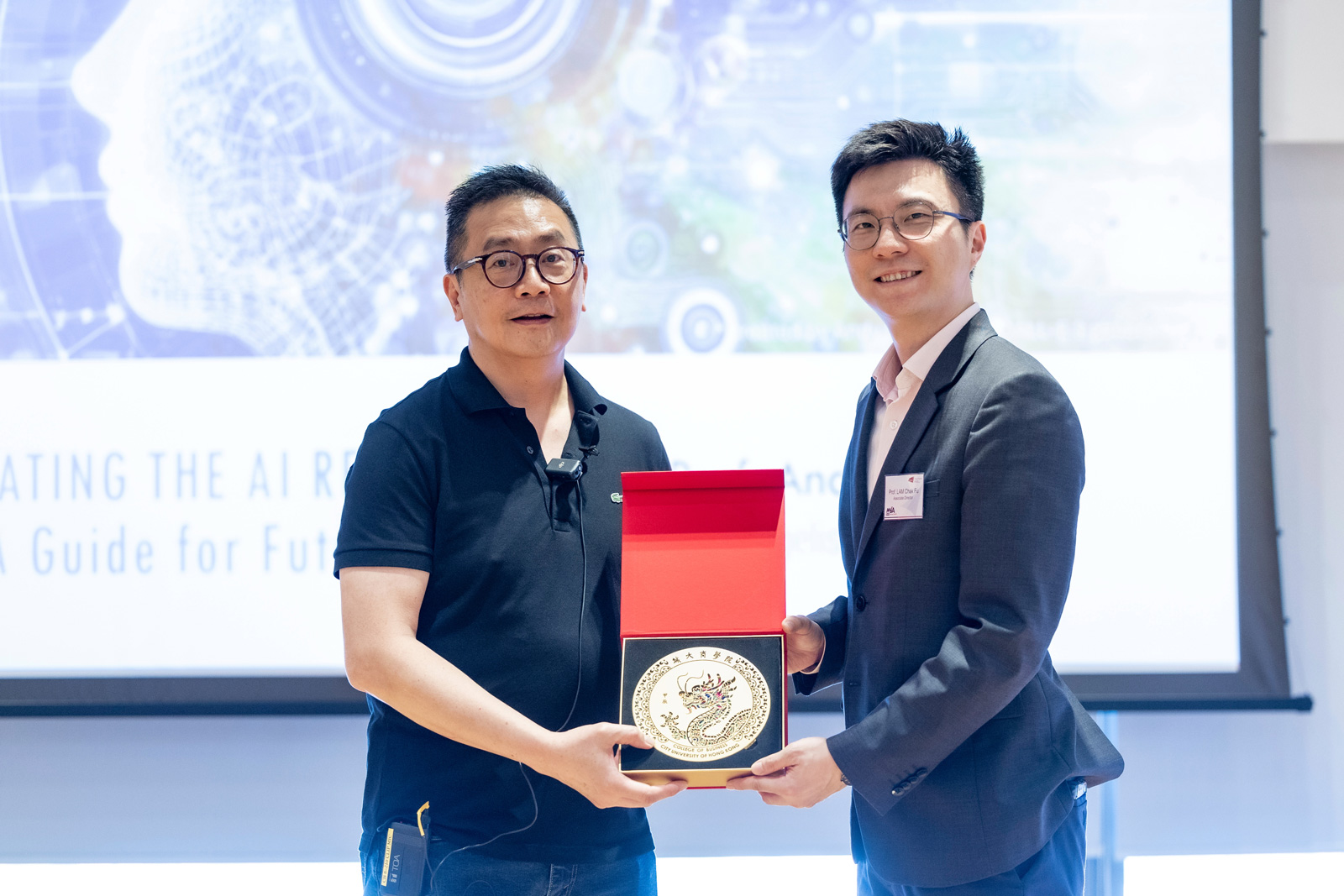 MBA Associate Director Professor Chak-fu Lam presents a token of appreciation to thank Professor Andy Chun for his support