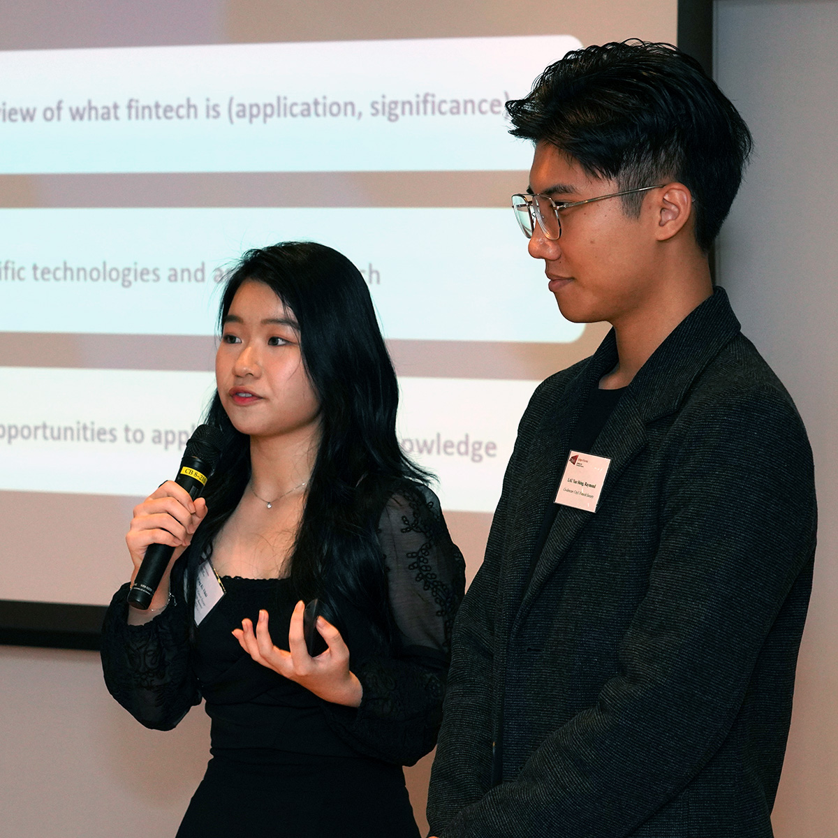 Co-directors of CityU Fintech Society, Lai Wing-ki (BBA Global Business) (left) and Raymond Lau Yau-shing (BBA GBSM) presents their work at the reception